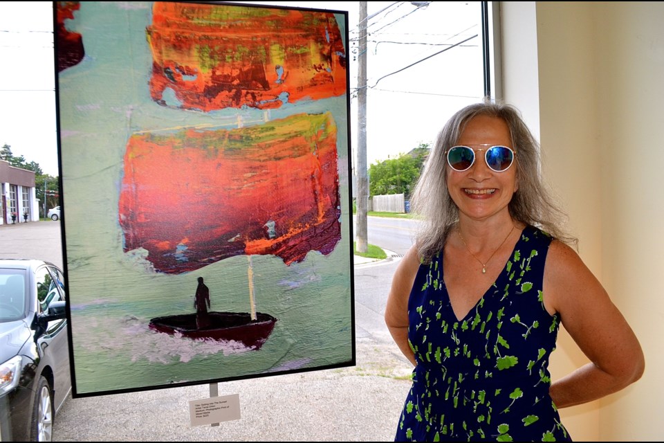 Artist and event organizer Tania Orton with her piece “Sailing Into the Sunset”. Troy Bridgeman for GuelphToday