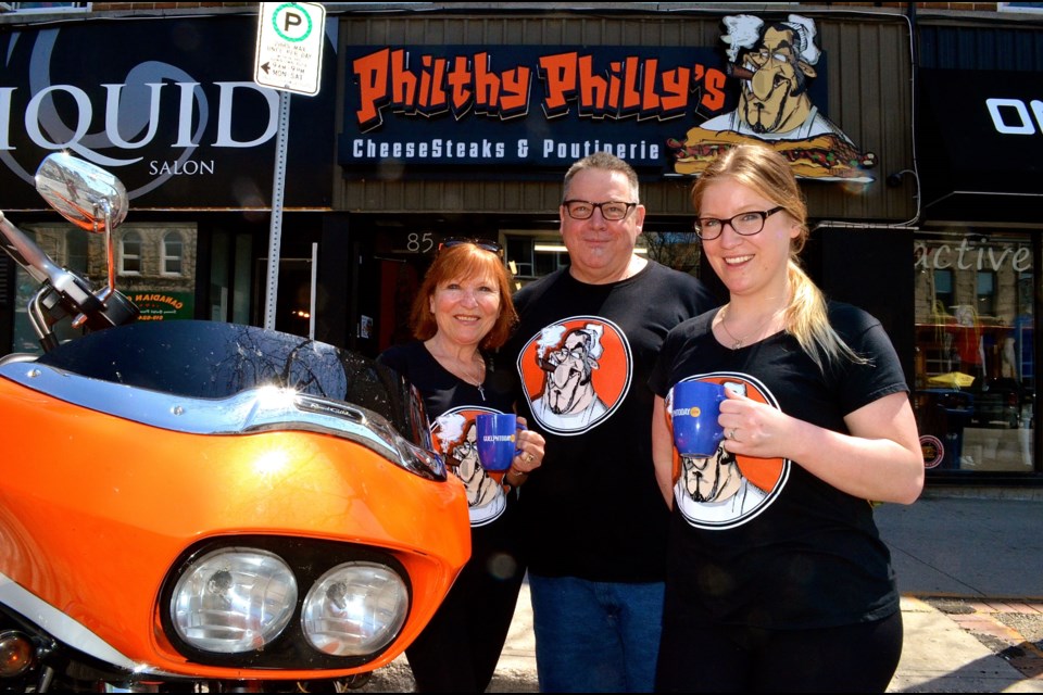 Lina and Mark Russell with their daughter and business partner Alysse Osbourne outside Philthy Philly’s their new restaurant on Macdonell.  Troy Bridgeman for GuelphToday.com