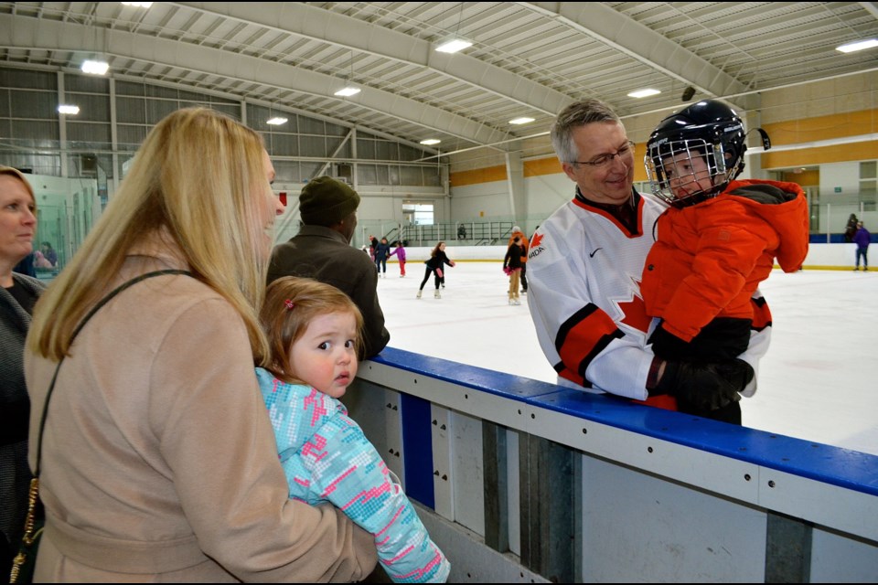Guelph MP Lloyd Longfield takes his grandson Michael for a spin around the rink during the New Years Levee at the West End Community Centre Sunday.  Troy Bridgeman for GuelphToday.com