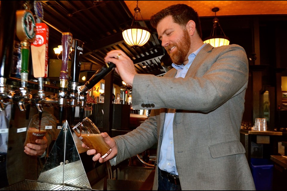 Sean Mangan demonstrates the art of pouring a perfect pint of Guinness. Troy Bridgeman for GuelphToday.com