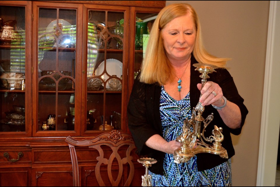 Wendy Smith examines a silver candelabra before taking it to an appraiser. Troy Bridgeman for GuelphToday.com