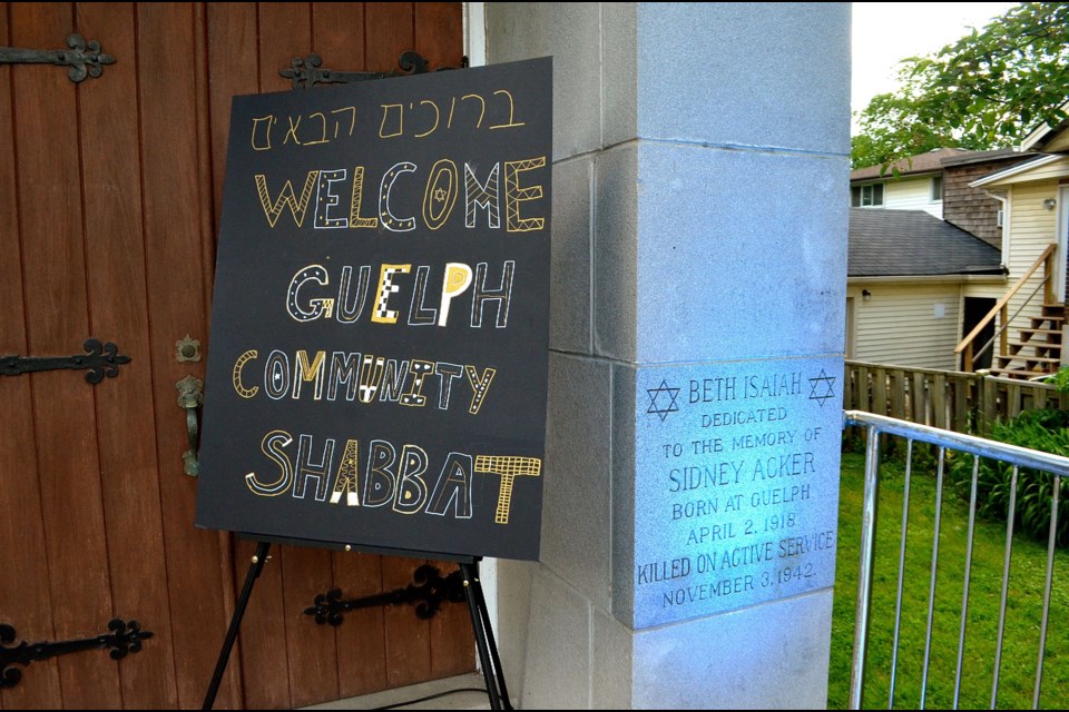 A sign at the entrance to Beth Isaiah Synagogue welcomes people to a special Shabbat Dinner and beside it is a dedication stone for Sidney Acker who was killed in action during the Second World War.  Troy Bridgeman for GuelphToday.com
