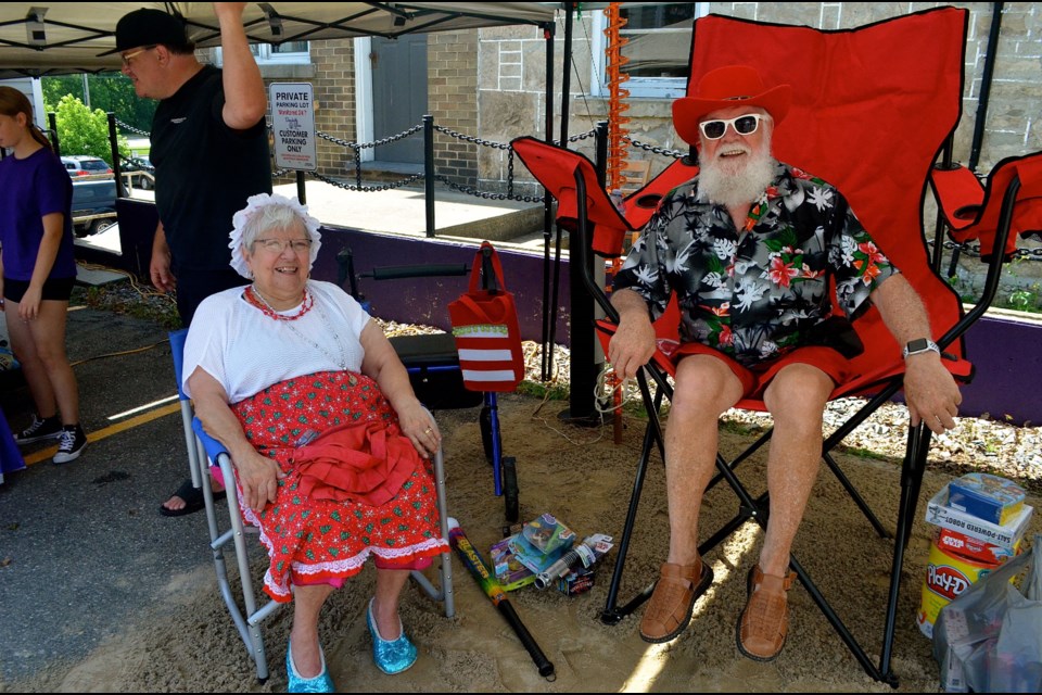 Santa and Mrs. Claus are keeping it cool in the shade during Christmas in July. Troy Bridgeman for GuelphToday.com