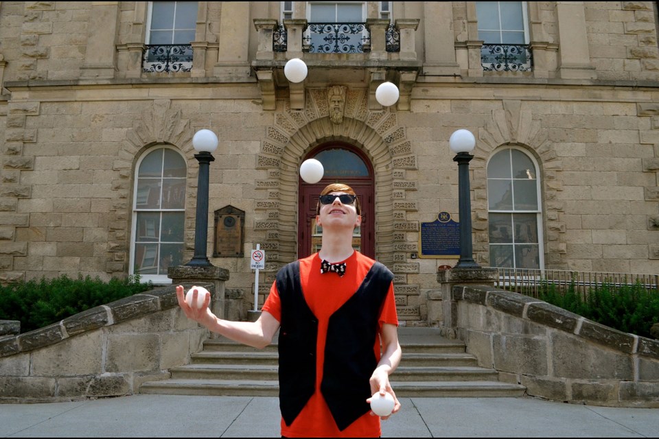 Teen magician and juggler Noah Nogueira has a lot of balls in the air outside old City Hall . Troy Bridgeman for GuelphToday.com