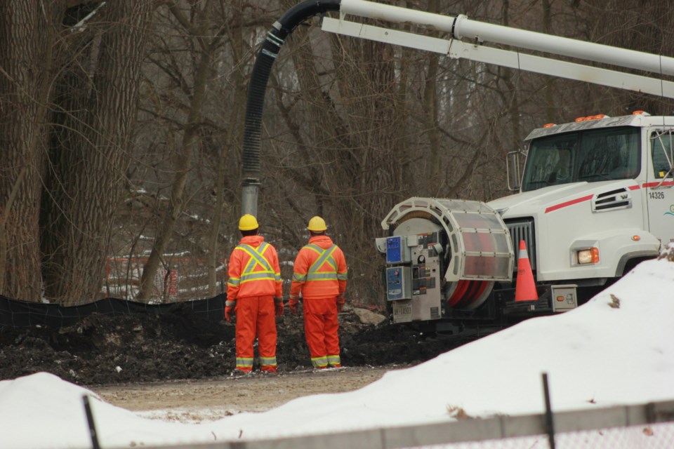 City crews clean up after a sewage spill along the banks of the Eramosa River just east of Lyon Park. Anam Khan/GuelphToday