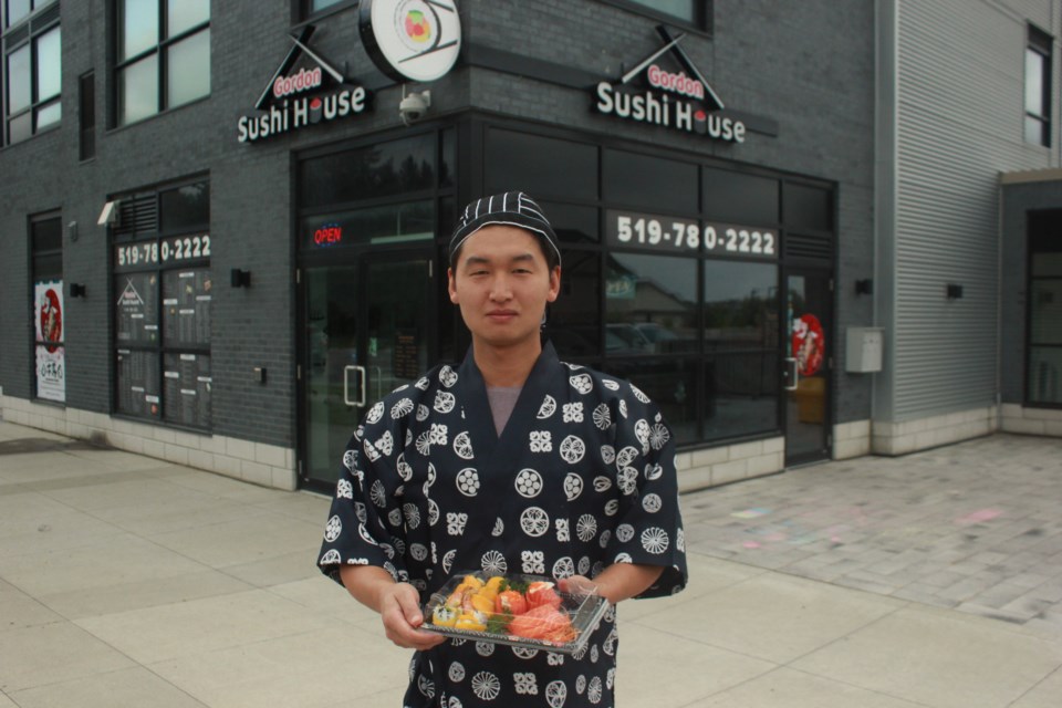 Sushi chef Sam Ma holds a tray of fresh made sushi. Anam Khan/GuelphToday