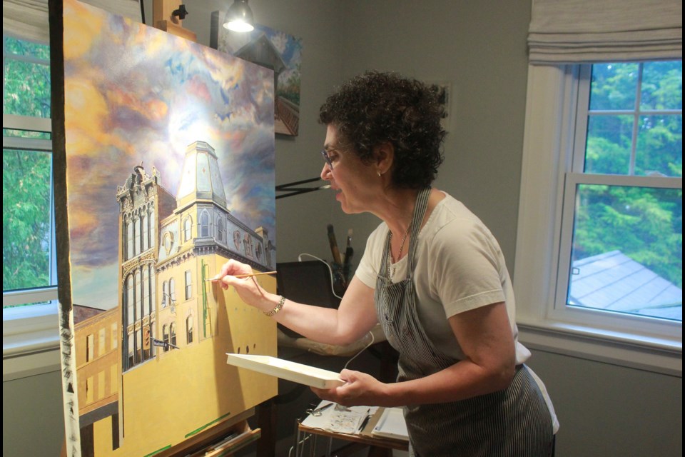 Barbara Salsberg Mathews paints the Soverign building. Anam Khan/GuelphToday