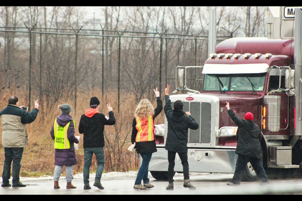 Activists stop an transport truck for two minutes Monday on Dunlop Drive. Anam Khan/GuelphToday