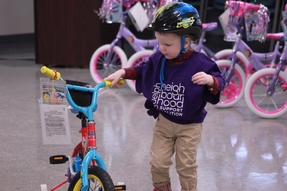 Guelph Neighbourhood Support Coalition's youngest member selects a bike for a test ride. Anam Khan/GuelphToday