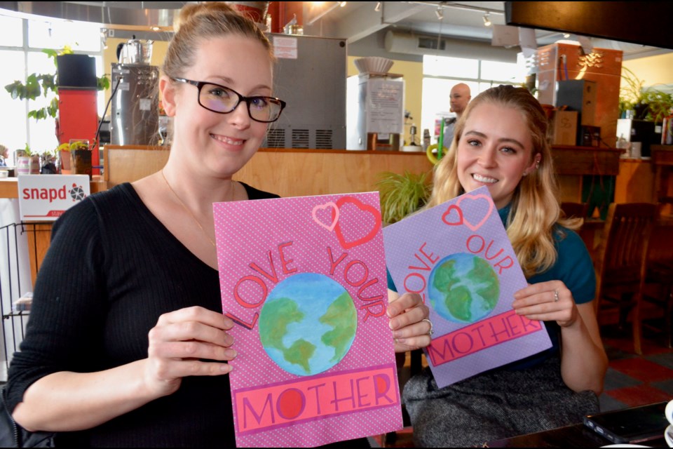 Meghan Lewis and MacKenzie Harris have prepared Valentines to present to banks for the Love Your Mother environmental campaign.  Troy Bridgeman/GuelphToday