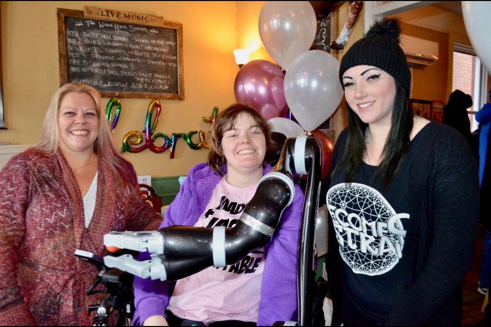 Danielle Workman, Maddy Workman and Katherine White celebrate Maddy’s new robotic arm during a party at The Wooly Pub Sunday. Troy Bridgeman/GuelphToday