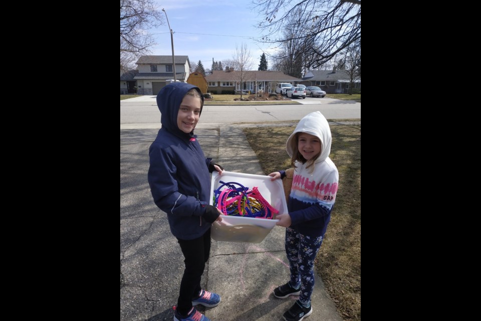 Grace and May Reid with a batch of headbands for InkSmith. supplied photo