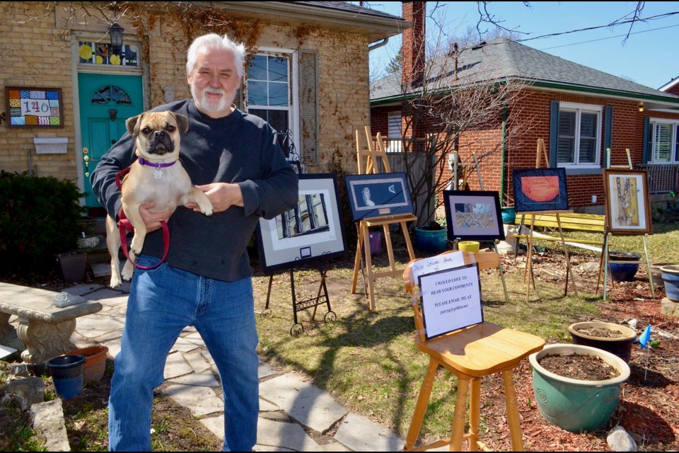 Art curator and restorative justice advocate Garry Glowacki and his companion Norman with a front yard exhibit of prisoners’ art. Troy Bridgeman/GuelphToday