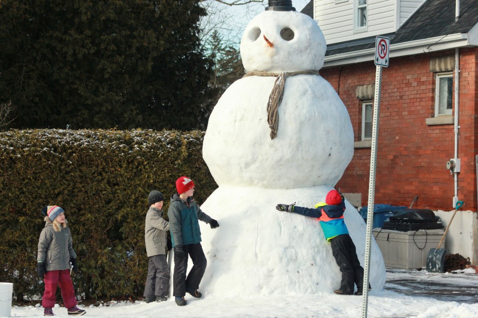 Kids hug the snowman. Anam Khan/GuelphToday