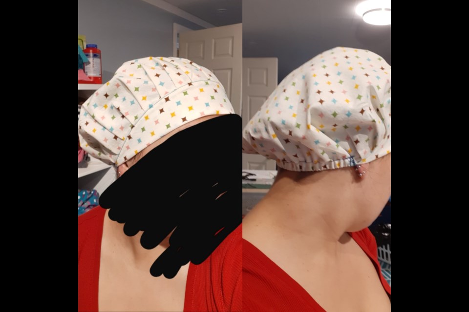 A woman tries on a scrub cap. Supplied photo