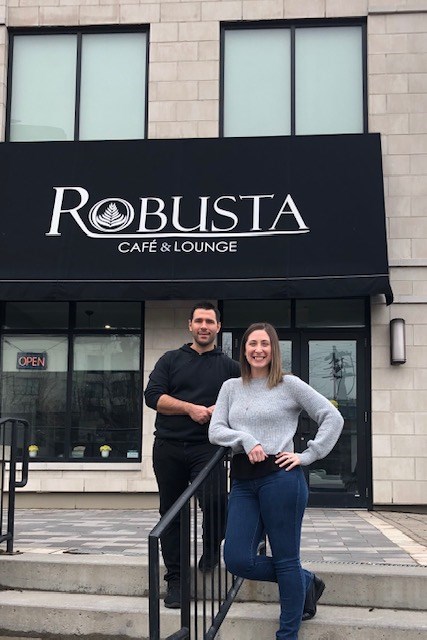 Husband and wife Danielle Davidson and Wessel Engelbrecht stand in front of their restaurant Robusta Cafe & Lounge on Macdonell Street. Supplied photo