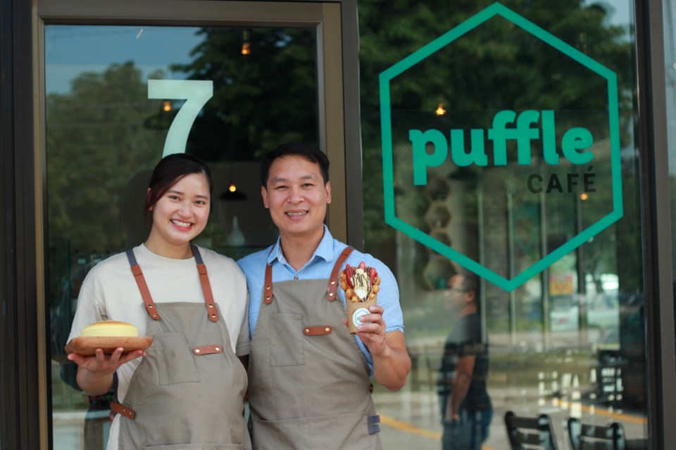 Linh Vu, left, holds a freshly-baked Japanese cheesecake while she stands beside her husband Khanh Tran holding a waffle. Anam Khan/GuelphToday