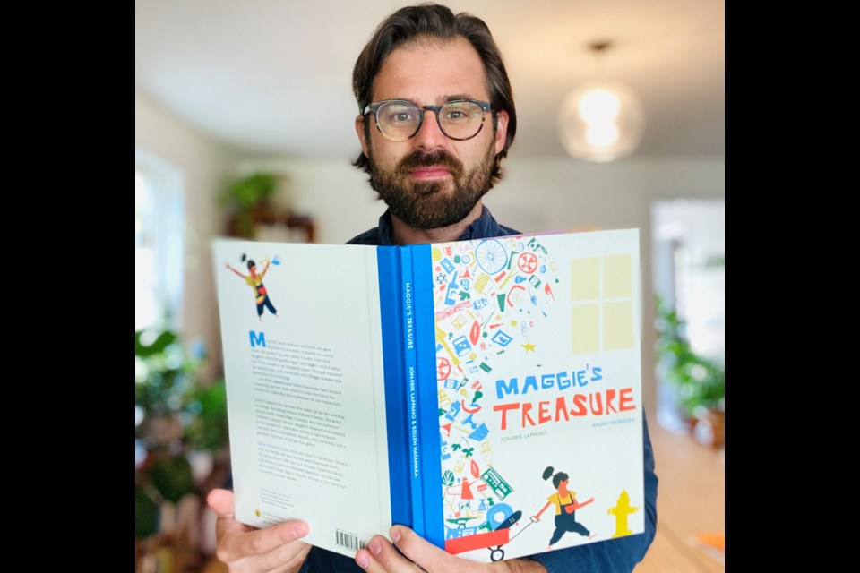 Jon-Erik Lappano holds a copy of Maggie’s Treasure. The book tells the story of a child who turns her passion for collecting everyday items she sees as treasures into something for her community.  Supplied photo