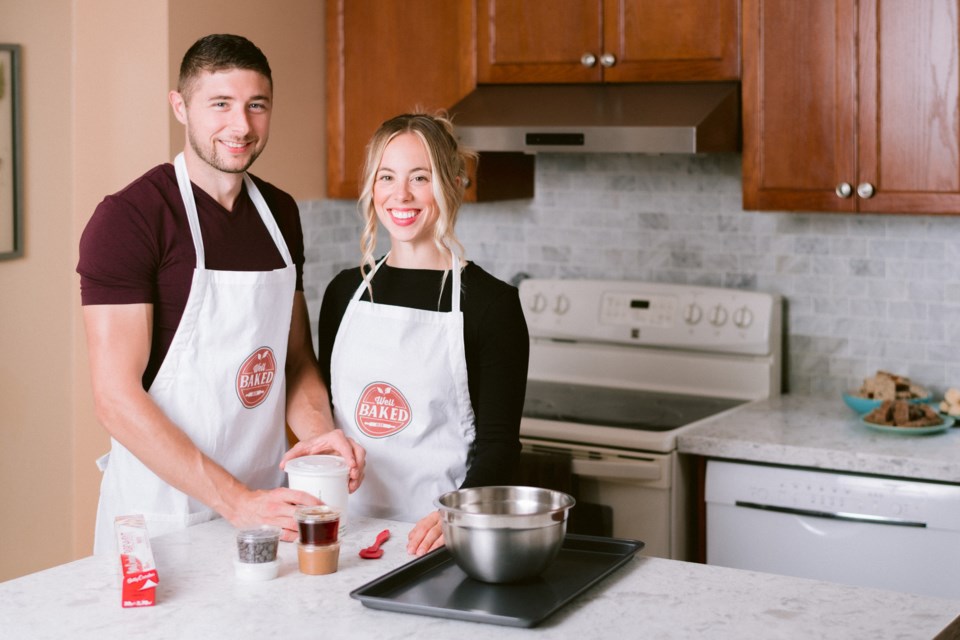 Stewart Russell and Courtney Russell stand with healthy ingredients used to create healthy snacks with Well Baked Box. Supplied photo