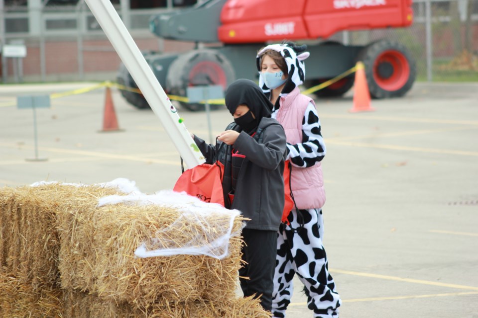Children collect their candy through chutes coming from ccess equipment machines. Anam Khan/GuelphToday