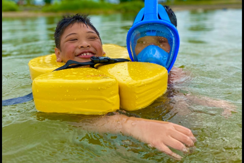 A Wish Fund child swims with his brother during a family vacation. 