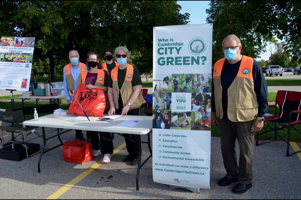 World Cleanup Day organizers (left to right)  John McDonnell, Debbie Robinson, Matt Forsyth,  Sandy Forsyth and John Forsyth distributed garbage bags, gloves and other cleaning supplies to participants at their new location outside Hespeler Arena.  