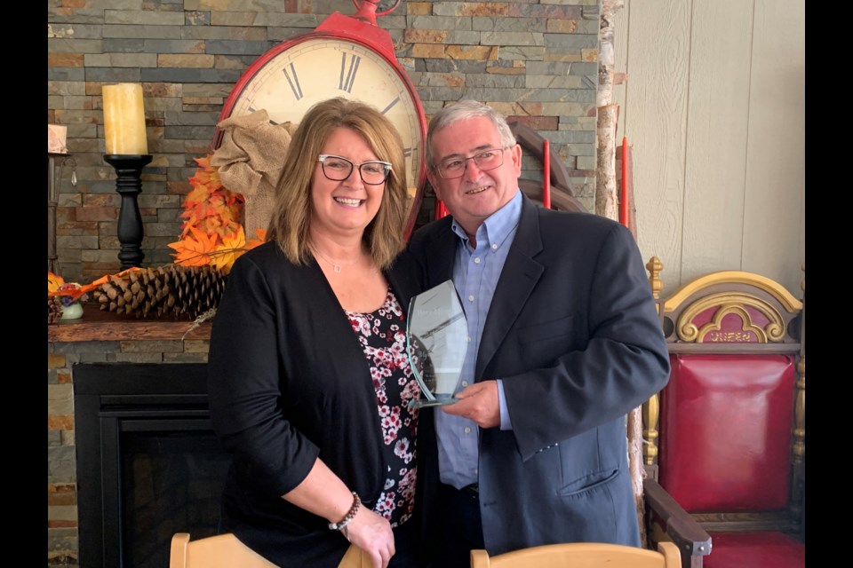 Myrna Hutchison is presented with the 2021 Neil Dunsmore Here4Help Power of One Award by Centre Wellington councillor Neil Dunsmore.