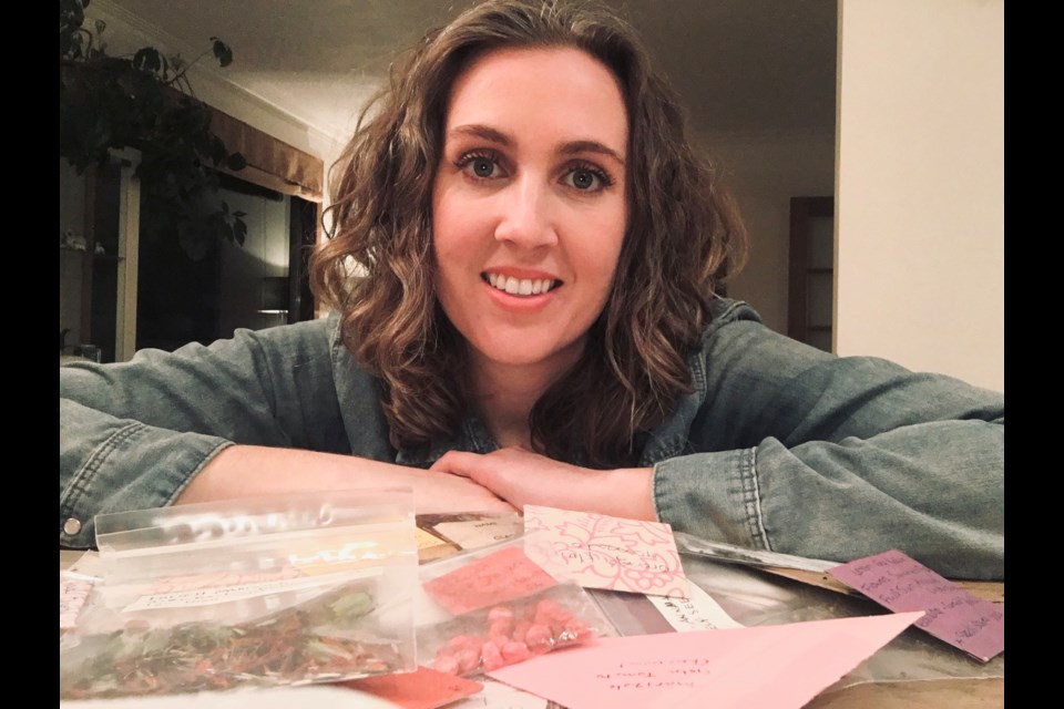 Karry Sawatsky sits in front of seed packages sent in by community members for the Community Seed Exchange initiative. Supplied photo