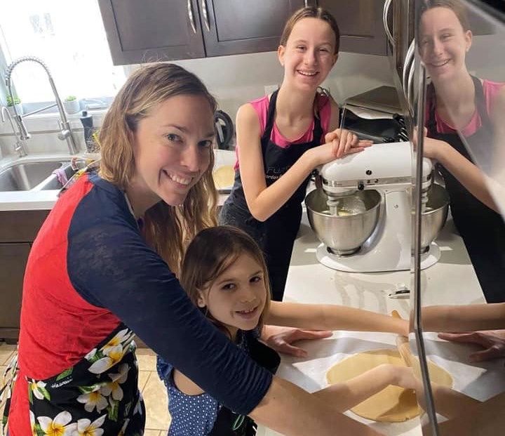 Catherine Boulding making cookie dough with her daughters Victoria and Emma. Supplied photo