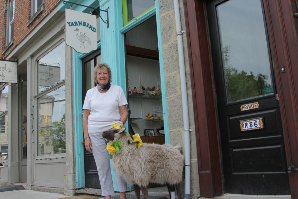 Marlene Pascoe stands outside her store with a synthetic sheep that is placed outside whenever her store is open. Anam Khan/GuelphToday