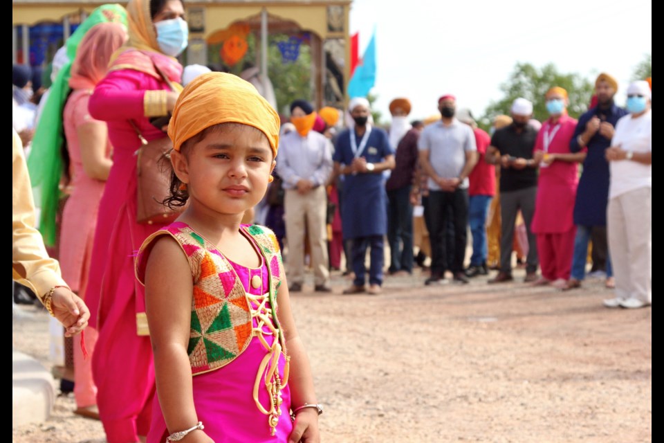 The community stands outside the Gurdwara awaiting the official opening prayer ceremony. 