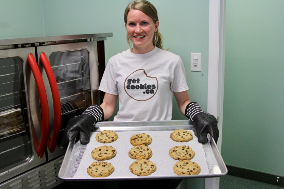 Bryanna Fox holds a tray of fresh baked cookies in her ghost kitchen on Speedvale Avenue. 