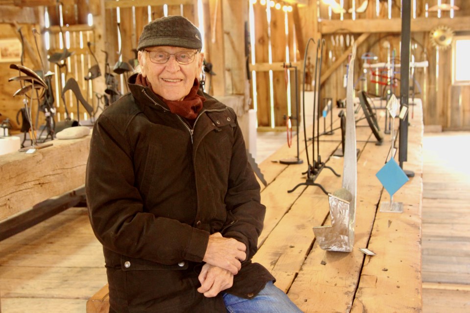 Andreas Drenters sits in a family barn that will host his last art show mid-October. 