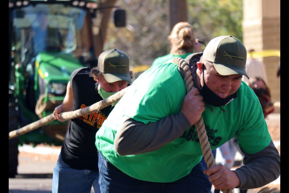 Students from the Ontario Agricultural College at the University of Guelph put their backs into it, lugging 10,000 lb tractors in teams of eight. The annual Tractor Tug for Tots event took place Tuesday on campus.