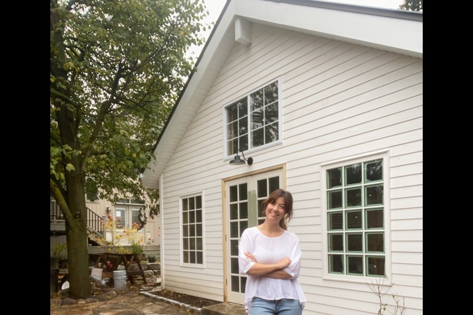 Jessica Imrie stands in front of her newly constructed building in her backyard called Hepburn House.