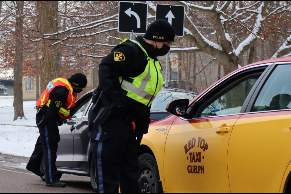 Officers perform RIDE checks at the corner of Waterloo Avenue and Wellington Street on Tuesday. 