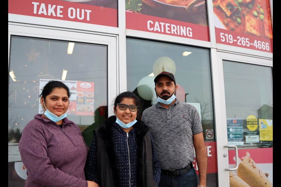 The Miani family stands in front of their restaurant Town's Heart. From left: Rupinder, Sohani and Sukhwinder