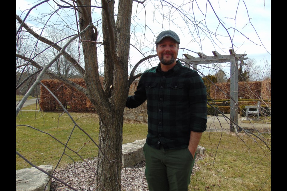 Sean Fox, senior research associate at the Guelph Arboretum, next to a white American elm cloned through the Elm Recovery Project.                                