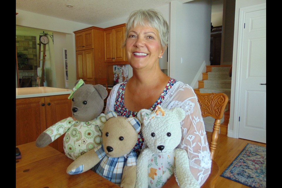 Mary Lord from Guelph with some of her handmade memory bears.                               