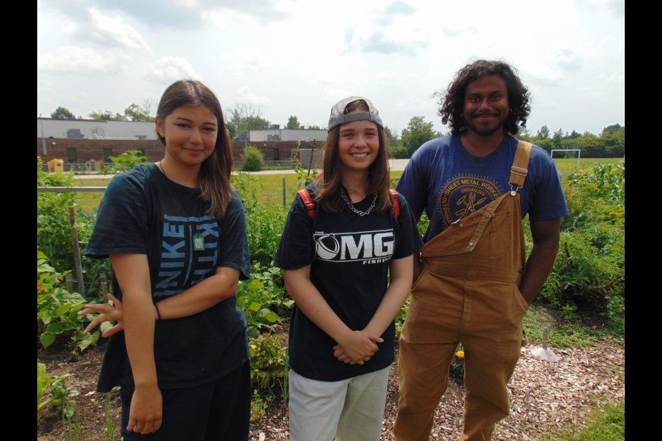 (left to right) Ilknoor Dahi, Sydney Johnstone from the Young Farmers in Plaid program with food system co-op manager, Julian Sivanadian.                                