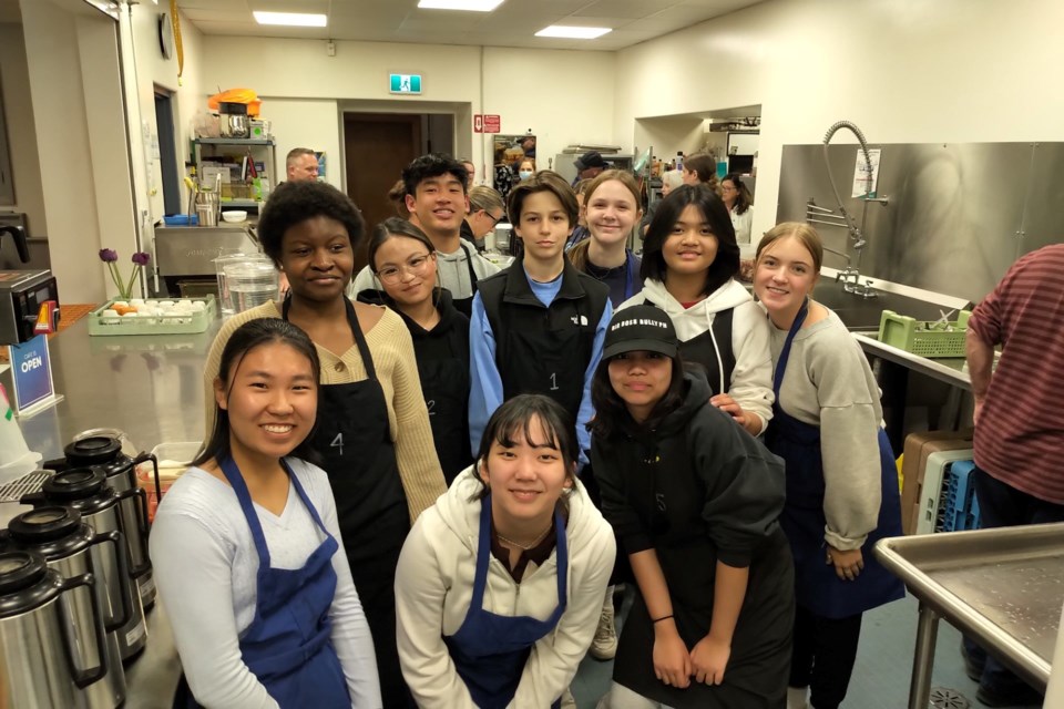 Staff and students from Wellington Catholic District School Board prepare a meal at Royal City Mission. 