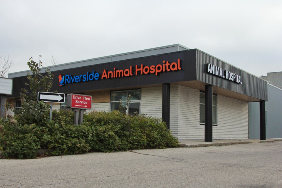 The building on 670 Woolwich St. currently has a sign that reads 'Riverside Animal Hospital.' The previous drive-thru sign is still in place. 