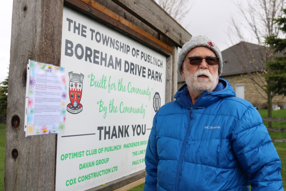 Bruce Taylor hangs up the new notice in Boreham Park. 