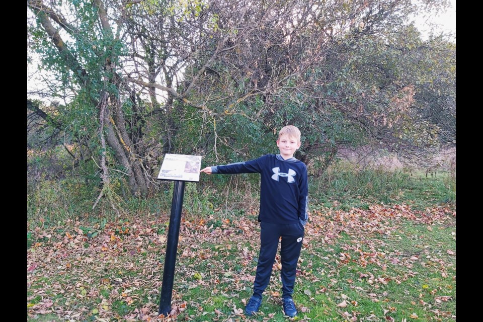 Connor Mulligan at the Pierpoint park beside the Richard Pierpoint plaque in Fergus.
