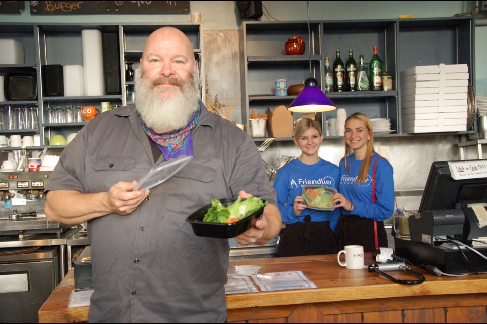 Mark Rodford, owner of The Cornerstone restaurant and Corner Market Guelph, holds a reusable container from A Friendlier Company, owned by Kayli Dale and Jacquie Hutchings. Richard Vivian/GuephToday