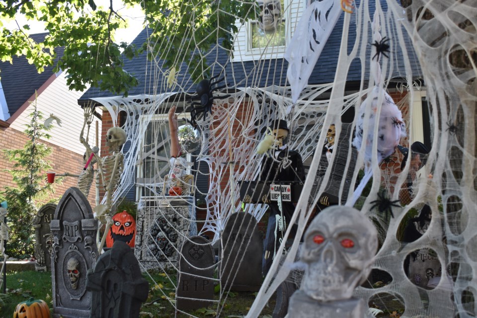 Giant spiders webs, tombstones and skeletons ward off any visitors from this house in Guelph. 