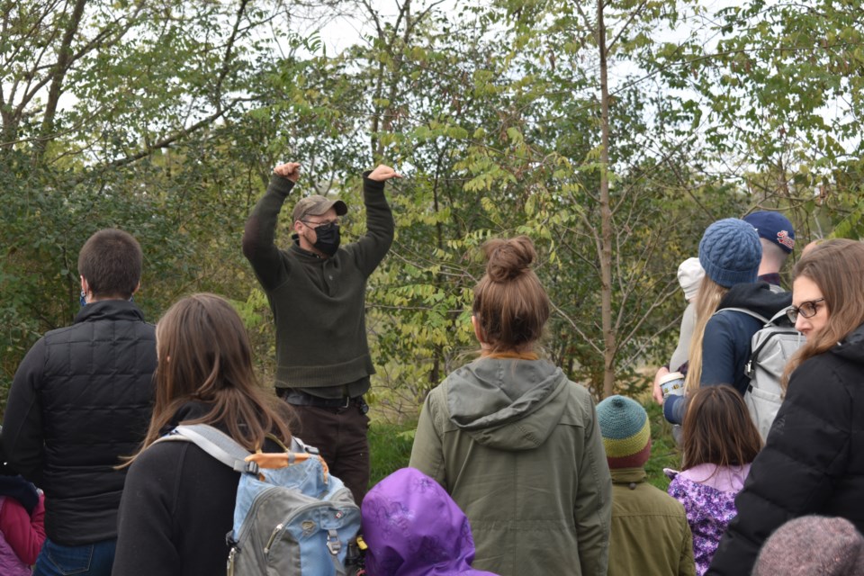 Outdoor School instructor Byron Murray teaches onlookers about the Siberian Pea Bush while answering questions from onlookers.
