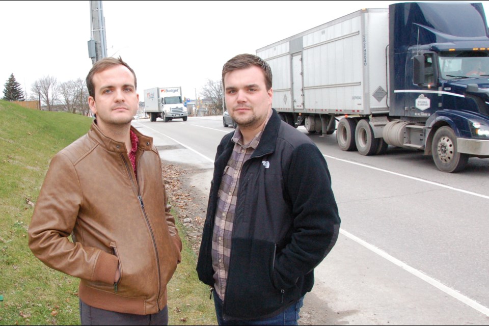 Brett Langlois, left, and Matthew Mooradian stand where there is no sidewalk on Gordon Street, between Poppy Drive and Gosling Gardens.