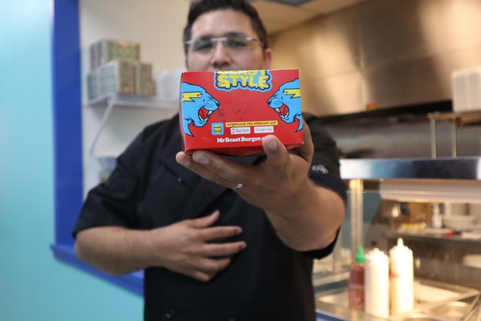 Naseem Kargil, owner of Shawarma Express, holds up a MrBeast Burger box, from the new ghost kitchen.