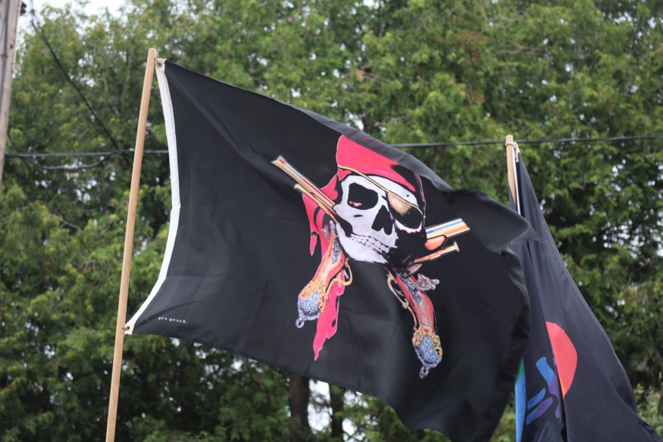 Pirate skeleton flag flying in the wind at the Ontario Pirate Festival at Marden Park.